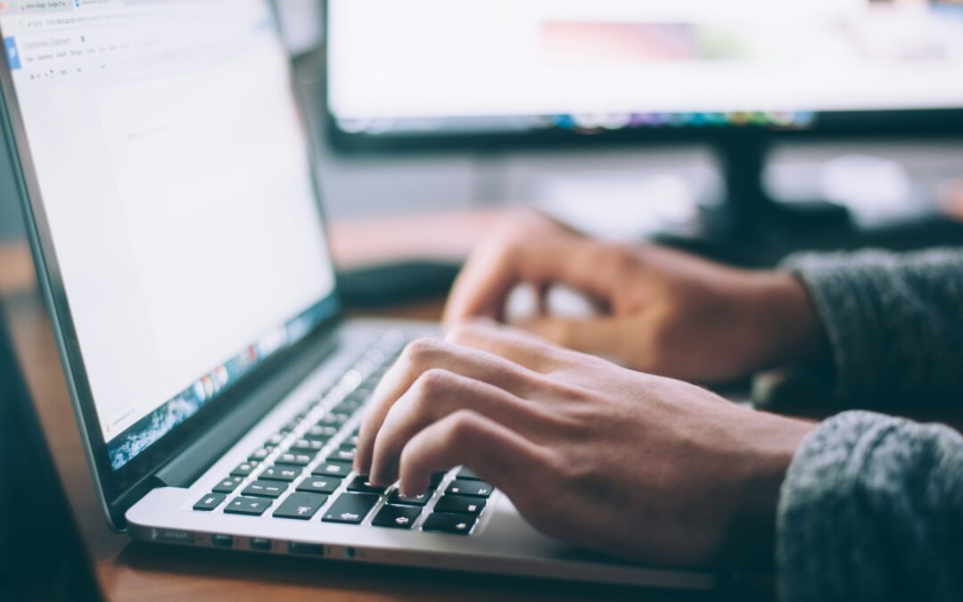 photo of person typing on computer